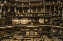 Man standing in temple ruins in Cambodia. 