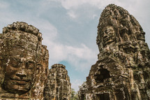 Faces carved in stone in a temple in Cambodia. 