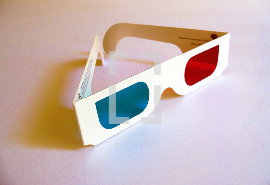 A pair of 3D glasses with blue and red lenses to see motion pictures and television in 3D just like movies from the 1950's to today that are filmed with 3D camera lenses to watch animated shows in 3D. 
