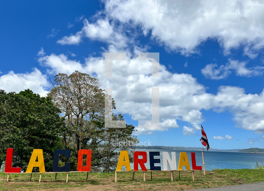 Lake Arenal in Costa Rica with colorful letter sign.

