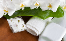 Spa accessories with orchid flowers on wooden table