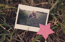 photograph of a couple lying in the grass 