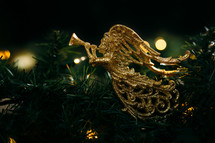 gold angel ornament on a Christmas tree 