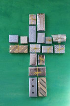 many little presents shaping a cross on green wooden background