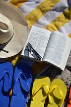 reading the bible at the beach in the family vacation. 
Bible, read, reading, study, studying, quiet time, quiet, time, family, summer, vacation, beach, sand, ocean, swimming pool, swim, swimming, free, free time, summertime, holiday, holidays, families, fun, sun, happy, colorfully, colorful, color, multicolored, blue, red, yellow, orange, flip flop, sandal, sandals, bathing shoe, bathing shoes, shoe, shoes, bathing, bath, thong, thongs, beach slide, beach slides, play, playing, relax, relaxing, chill, chilling, towel, glasses, sunglasses, sunhat, sun hat, sun bonnet, bonnet, sun shade, shade, sunshine, sun, shine, shining, size, different, various, father, mother, child, children, open, Corinthians