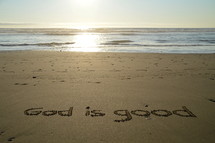 writing in the sand: God is good. 