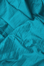 bright turquoise satin fabric as neutral background