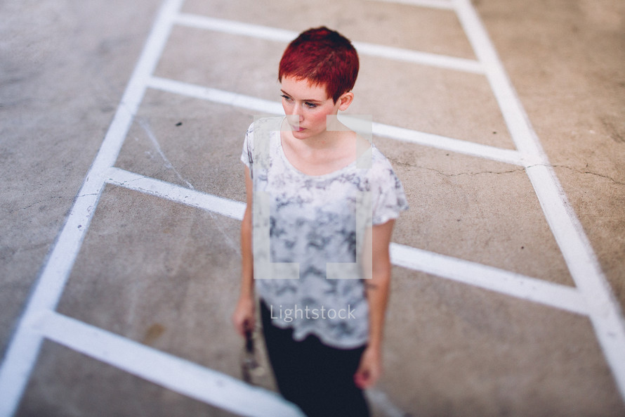 woman standing in a parking lot 