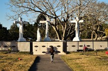 a girl running toward a mausoleum