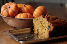 pumpkin bread and pumpkins in a bowl in a kitchen 