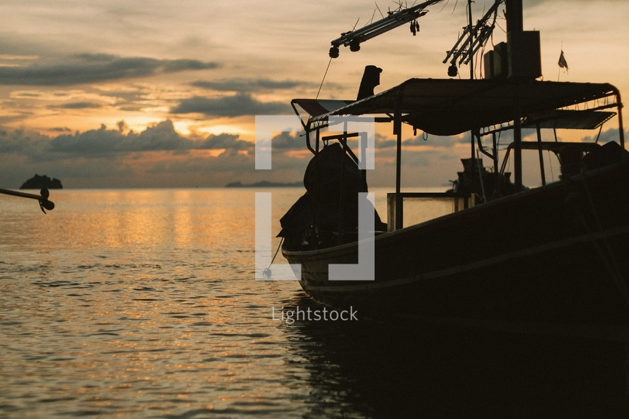 A fishing boat on the water at dusk. 