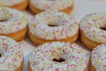 sugarcoated donuts with colorful sprinkles