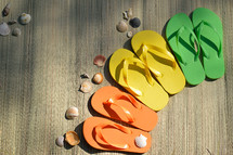 flip flops and seashells on a mat 