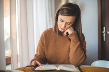 a woman reading a Bible 