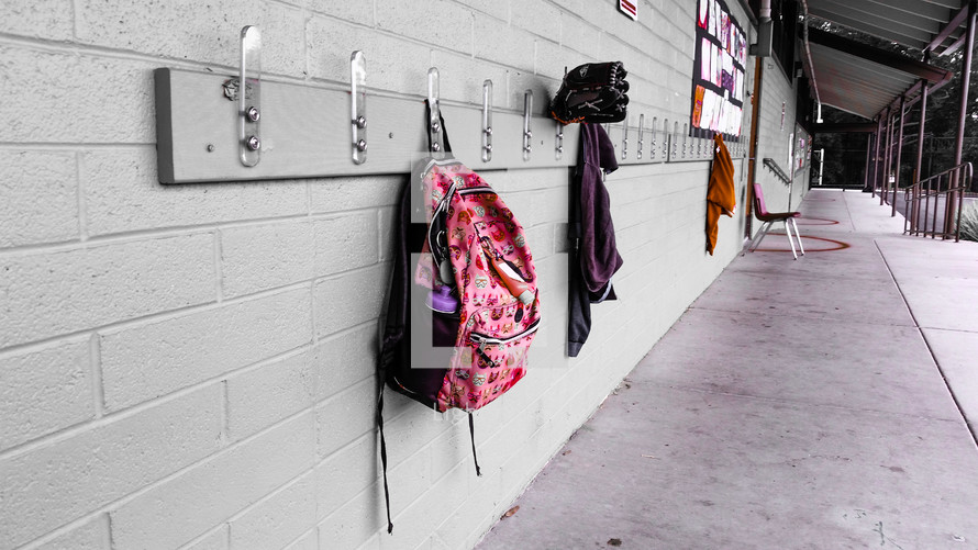 book bags hanging on hooks 