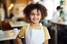 child with apron in restaurant