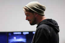 side profile of a man in wool cap 