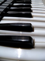 keyboard keys of an electronic piano musical instrument black and white ivory keyboard.