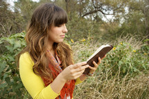 woman reading her Bible outdoors 