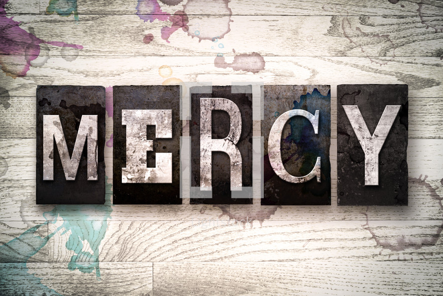 word mercy on white washed wood