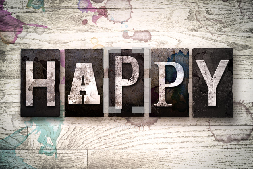 word happy on white washed wood