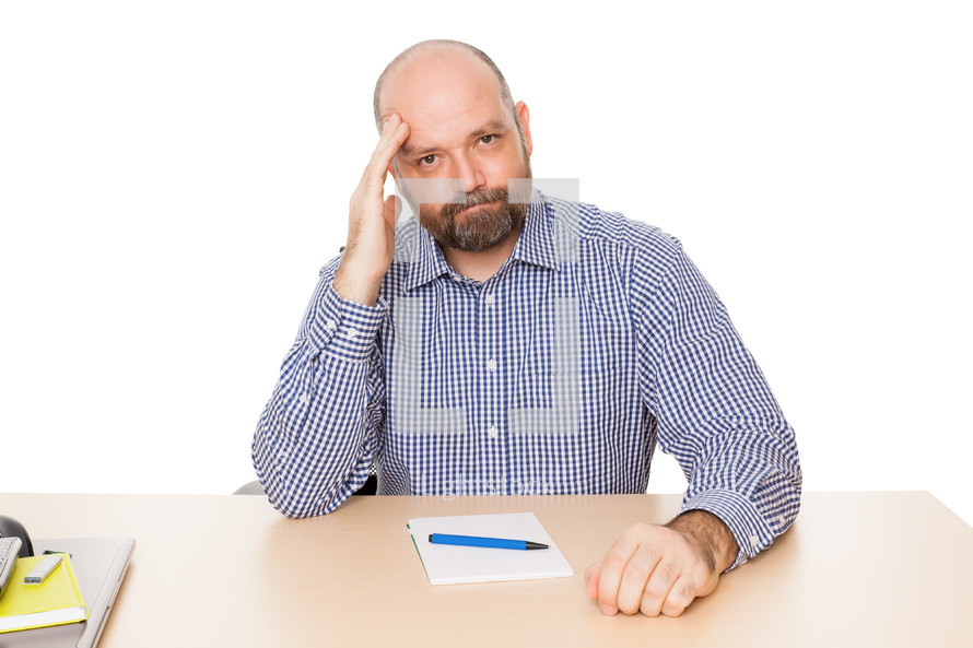 a man thinking sitting at his desk 