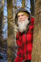 lumberjack standing beside a tree