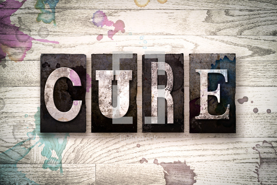 word cure on wood background 