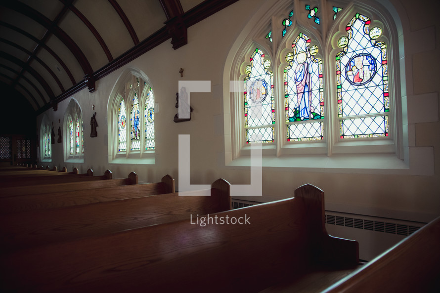 stained glass windows and pews 