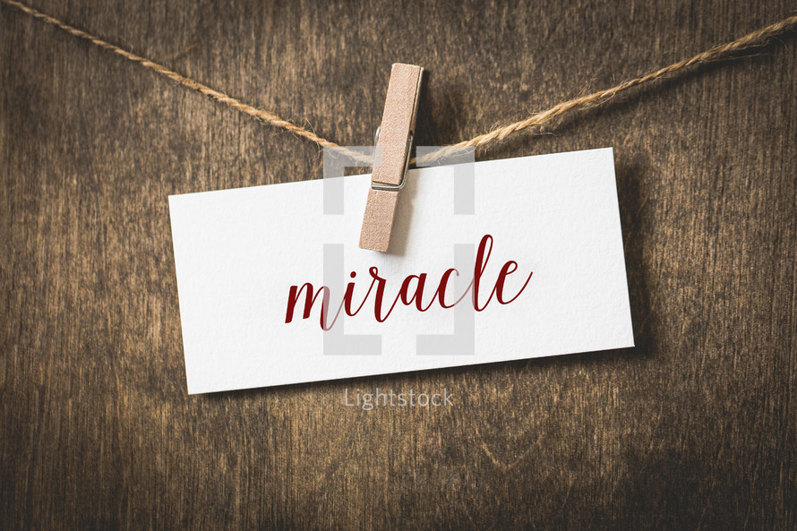 word miracle on white card stock hanging from a clothespin on a clothesline 