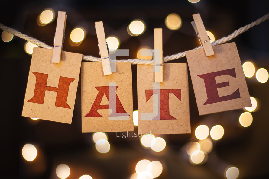 word hate hanging on clothes pins 