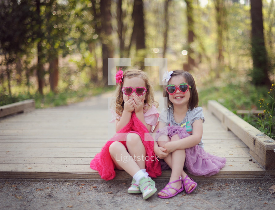 children in sunglasses sitting outdoors 