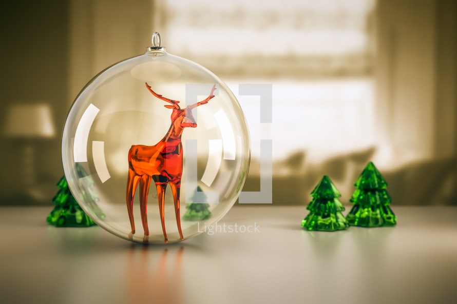 glass reindeer ornament and trees 