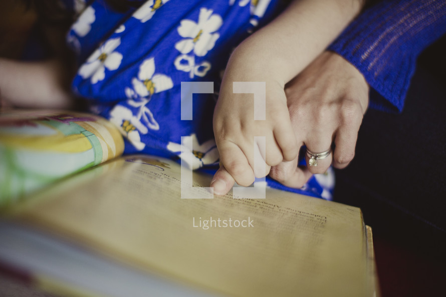 mother and daughter reading a children's Bible together