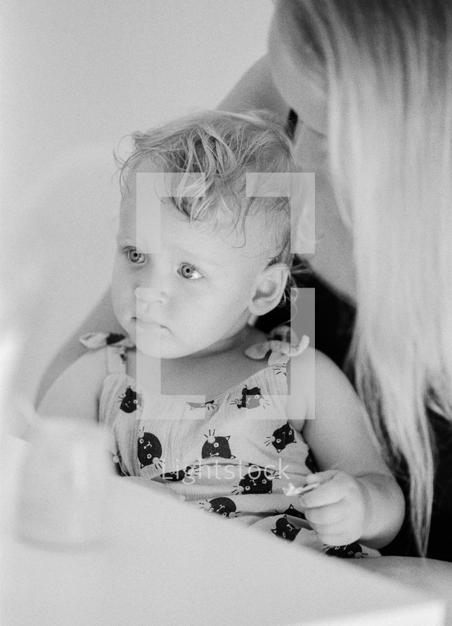 Black and white portrait of baby girl with mum at home