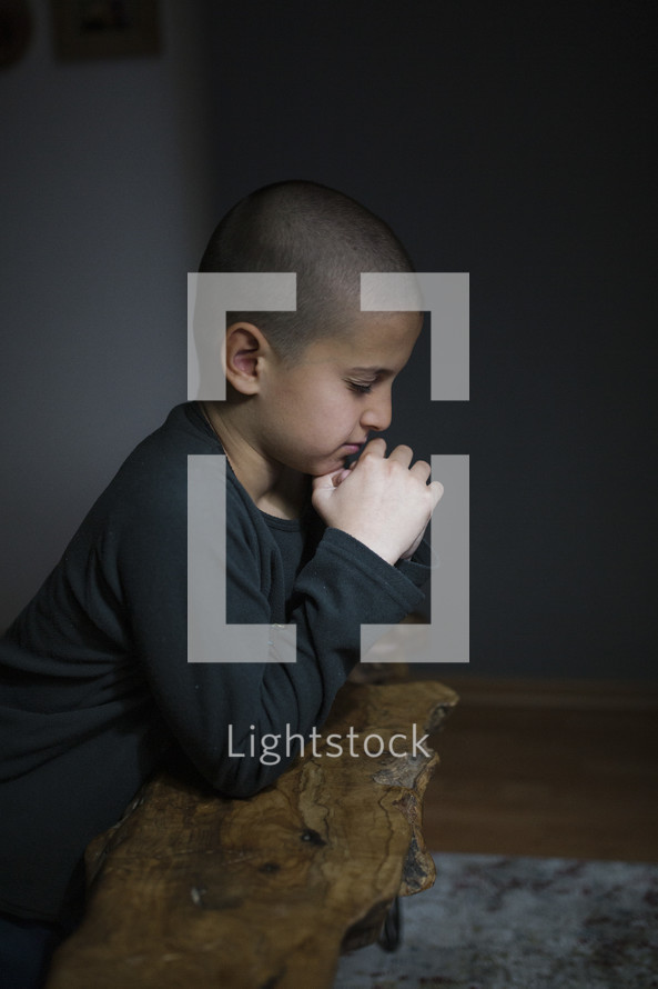 Little boy praying.