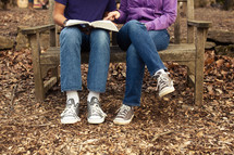 young man and a woman reading a Bible - mentoring 