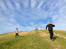 father and son running down a hill
