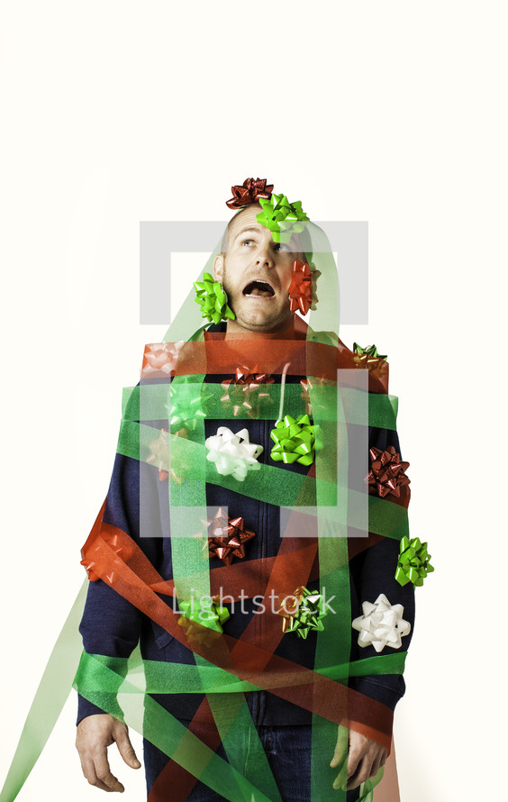 A man being consumed by the commercialism of Christmas.