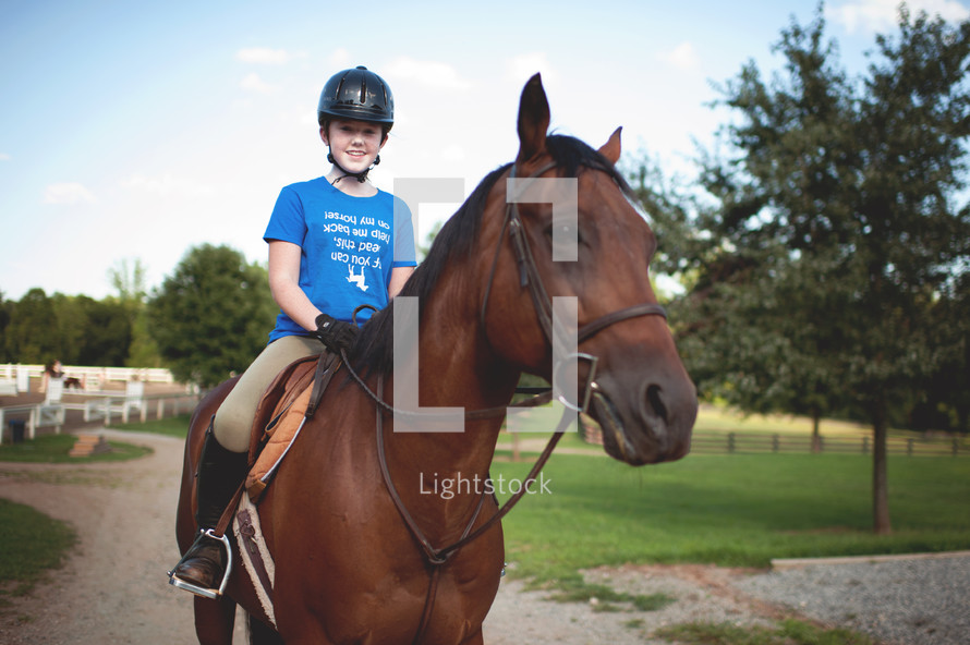 a teen girl riding a horse 