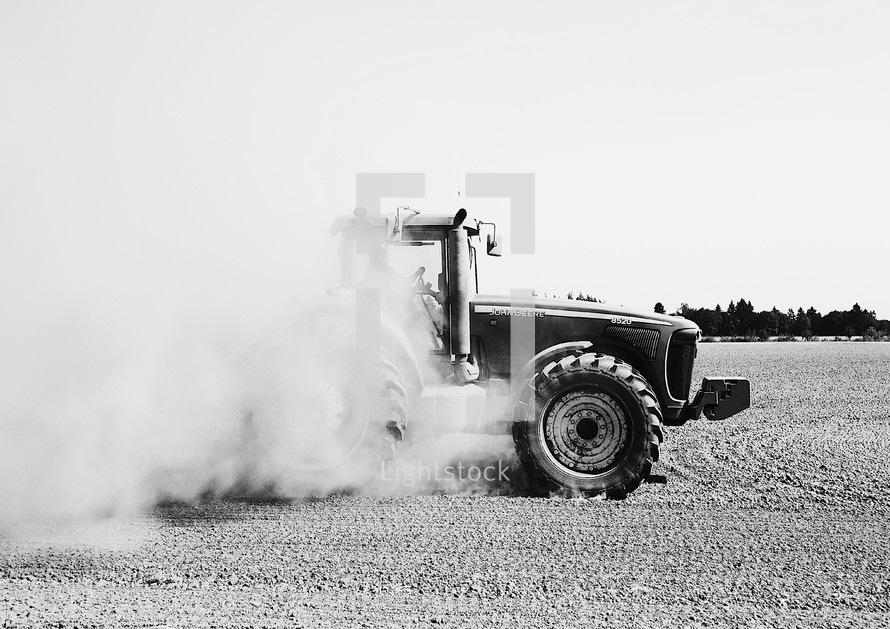 tractor stirring up dust 