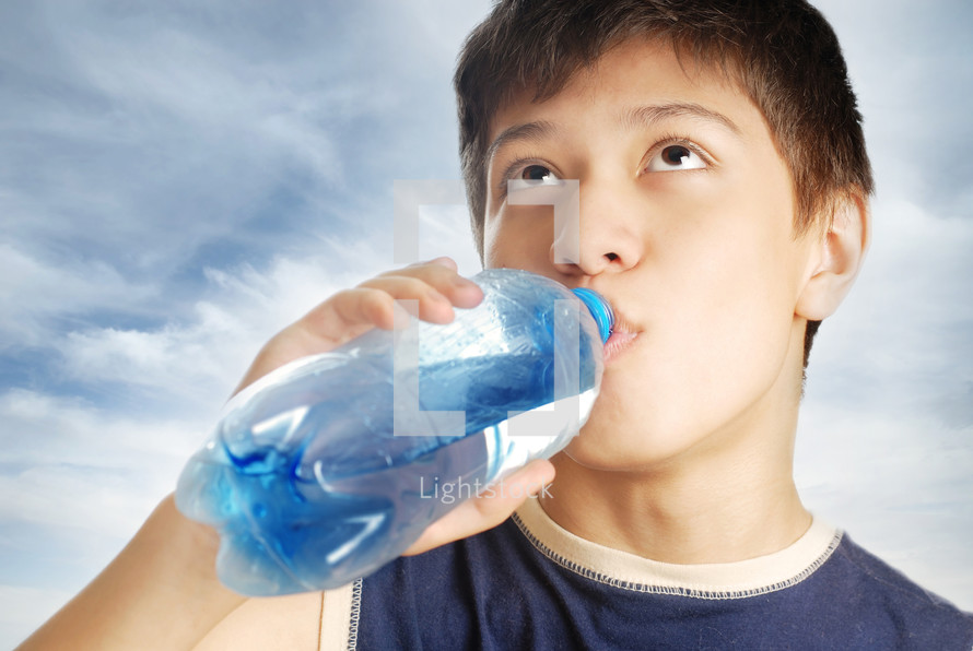 boy drinking a bottle of water 