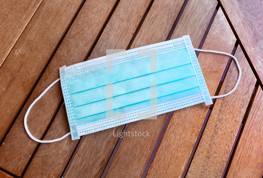 surgical mask on a wood background 