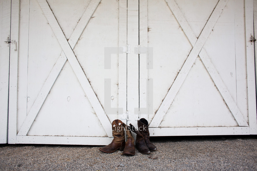 Mens and Women's boots by a barn