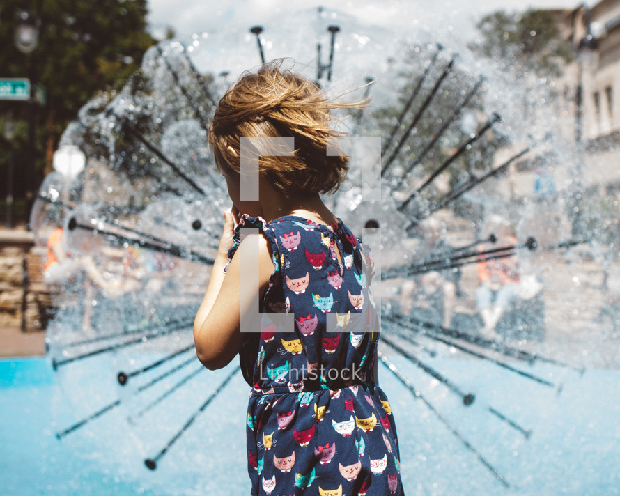 a girl child at a splash park 