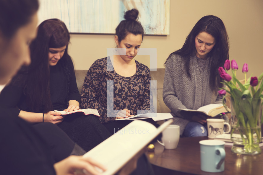 women reading Bibles at a Bible study 