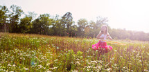 little girl dancing in a field of wild flowers
