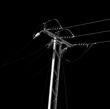 power lines against a dark sky 