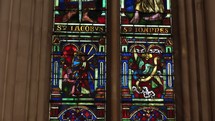 Glasswork of saints in light inside of church