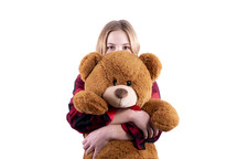 child hugging a teddy bear 